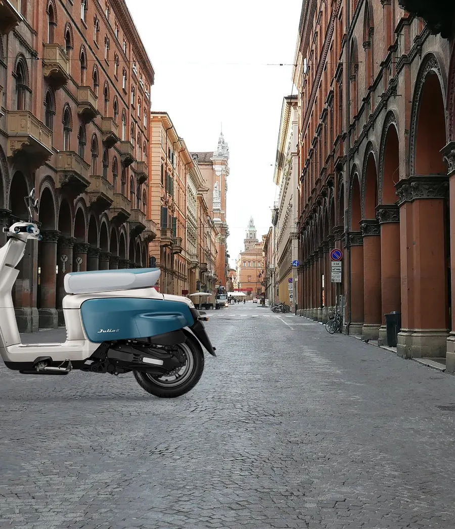 A white and teal Julio II parked under an Italian portico